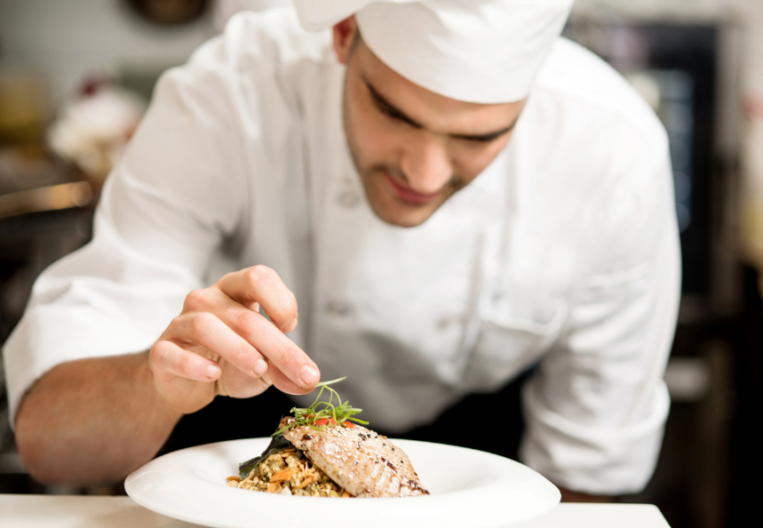 Chef garnishing food to serve in a restaurant